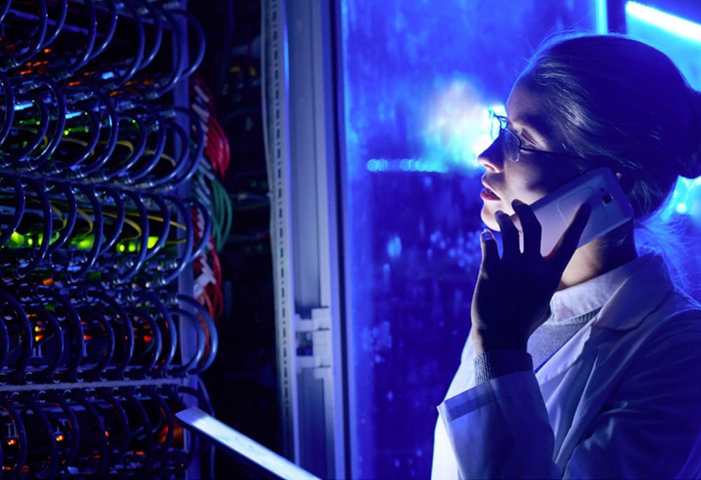 woman talking on mobile phone in front of a data center